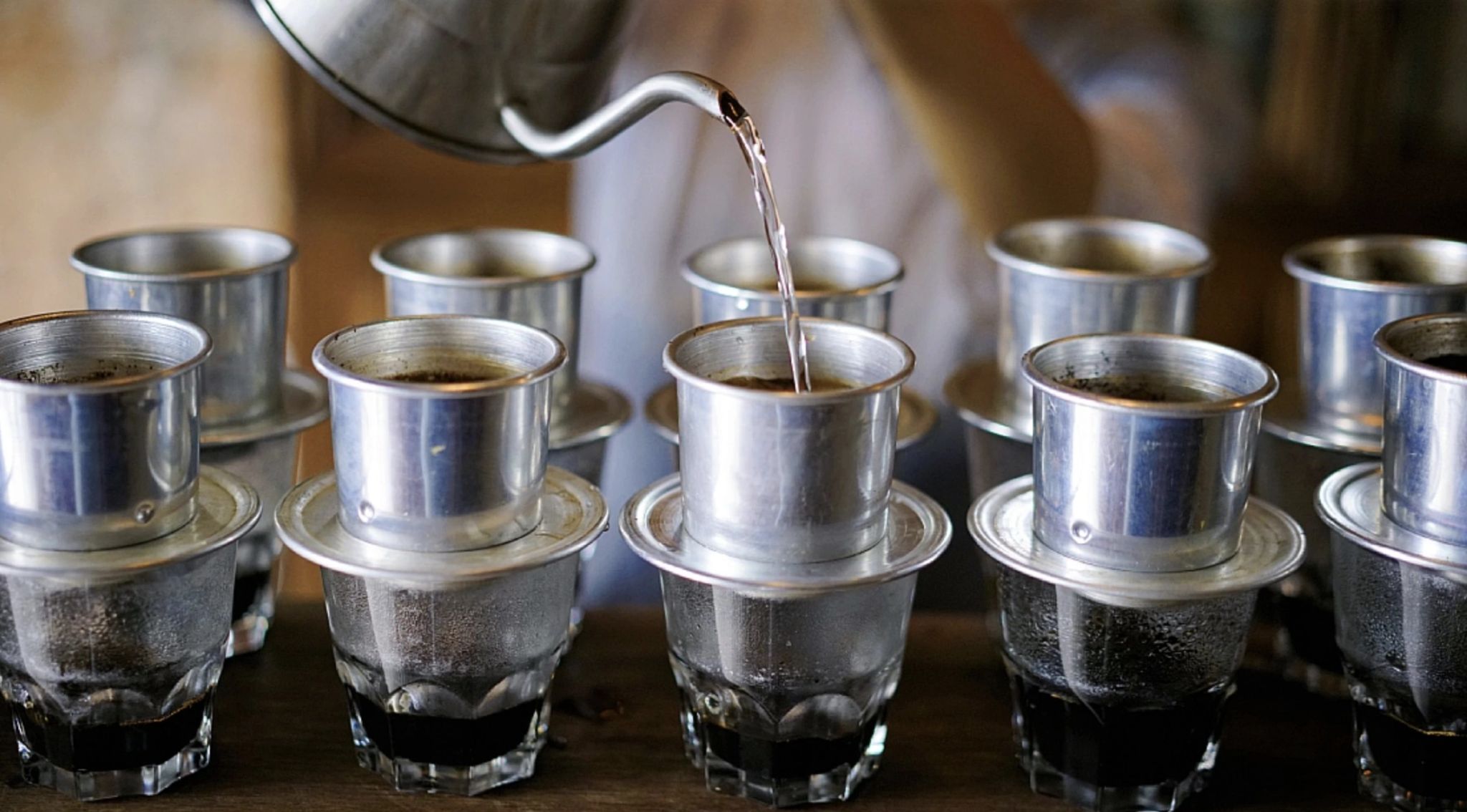Colorful array of different Vietnamese coffee variations served in traditional glasses
